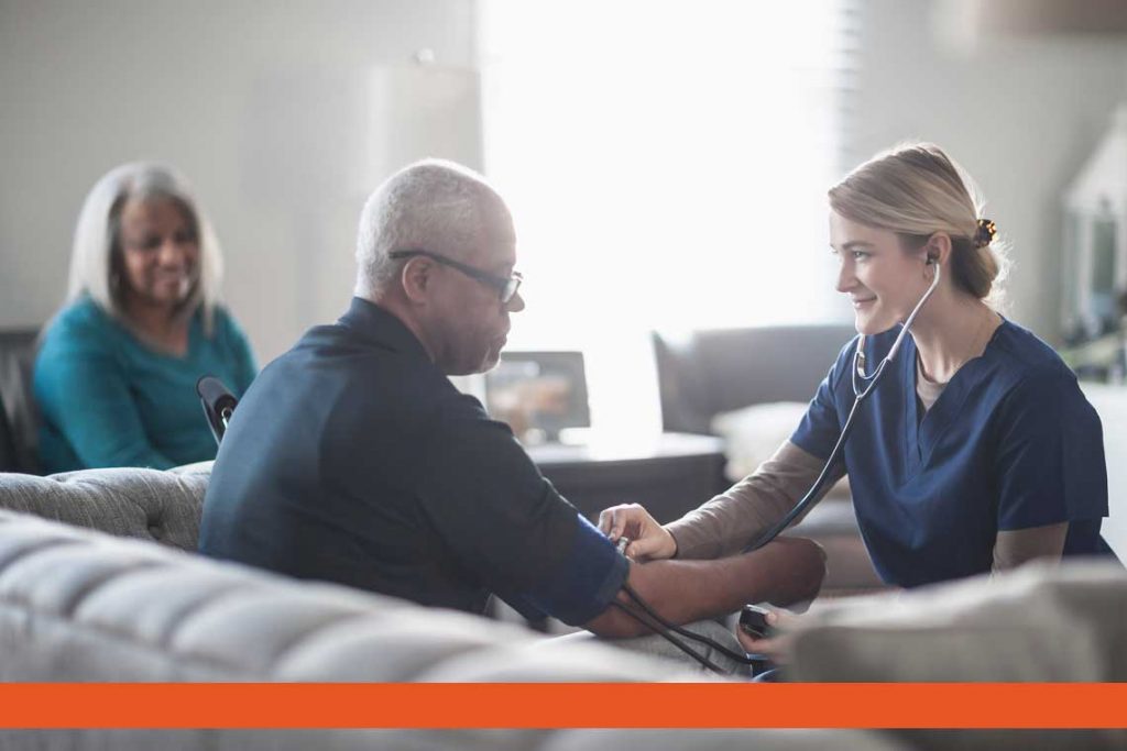 nurse using stethoscope to check patient's heartbeat