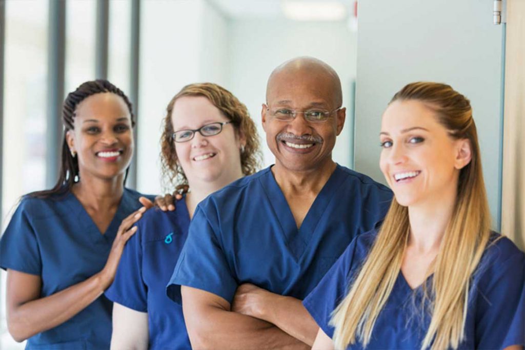 four nurses smiling