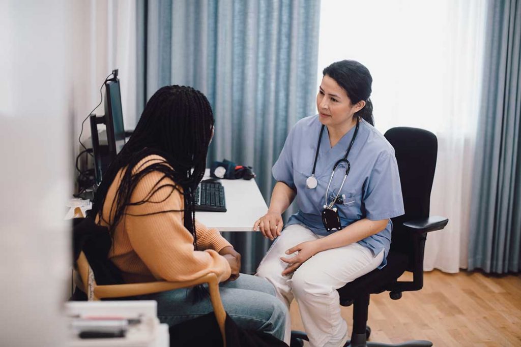nurse sitting with patient