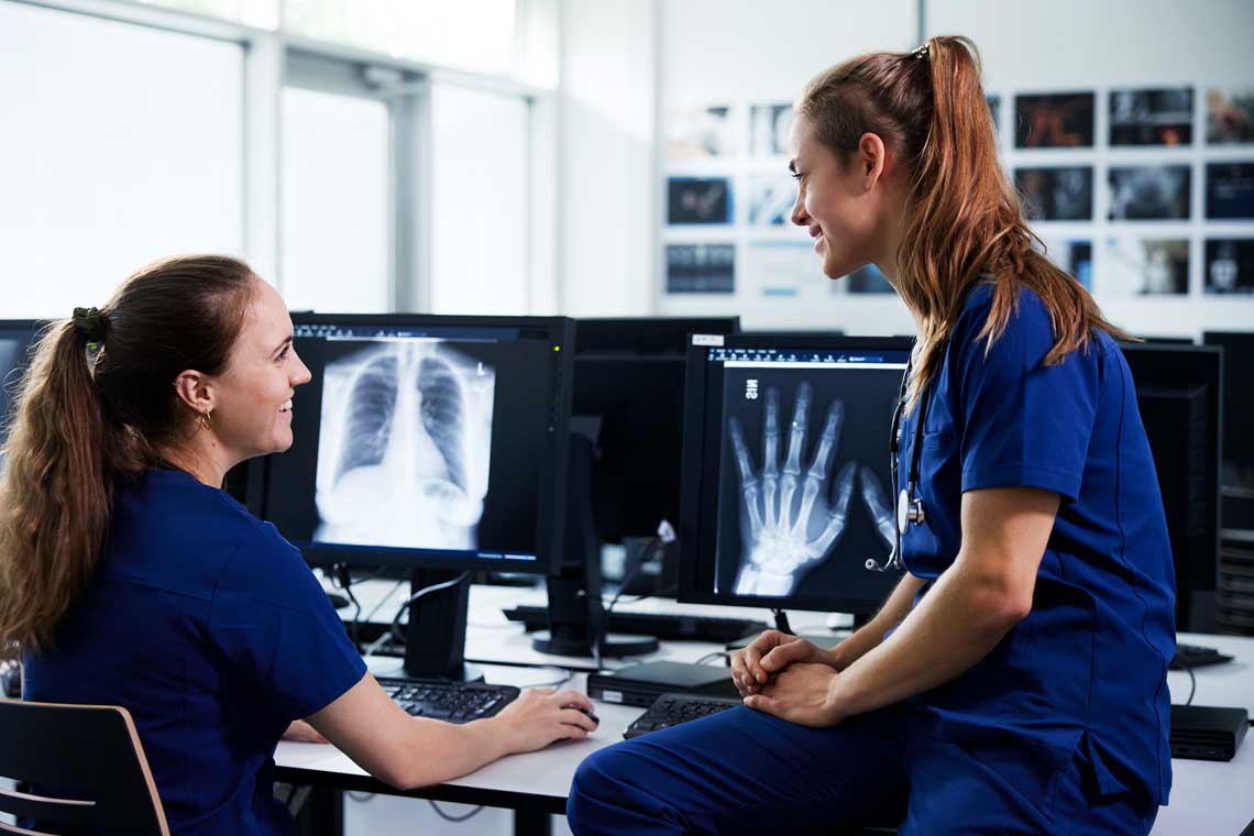 nurses looking at X-Ray scans