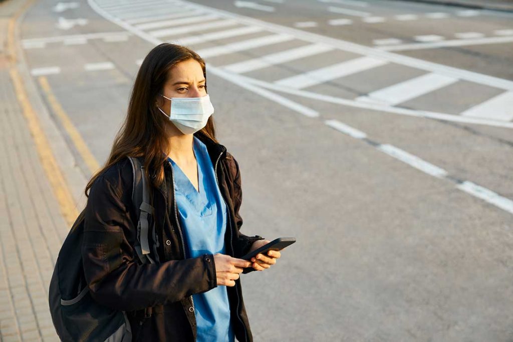 nurse on roadside holding phone