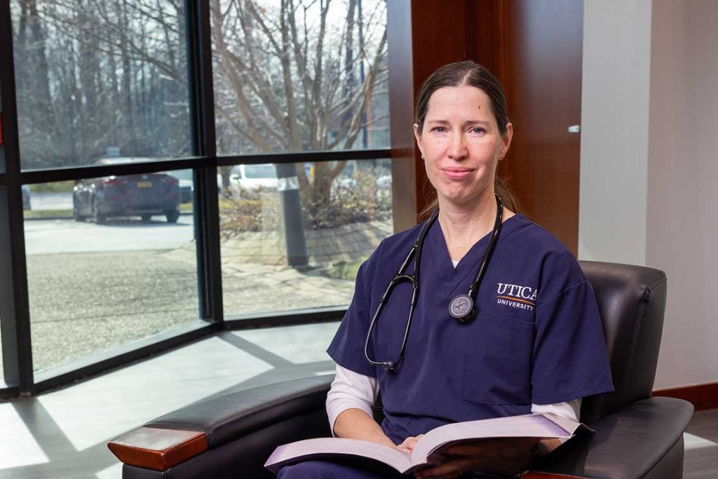 ABSN student smiling with textbook