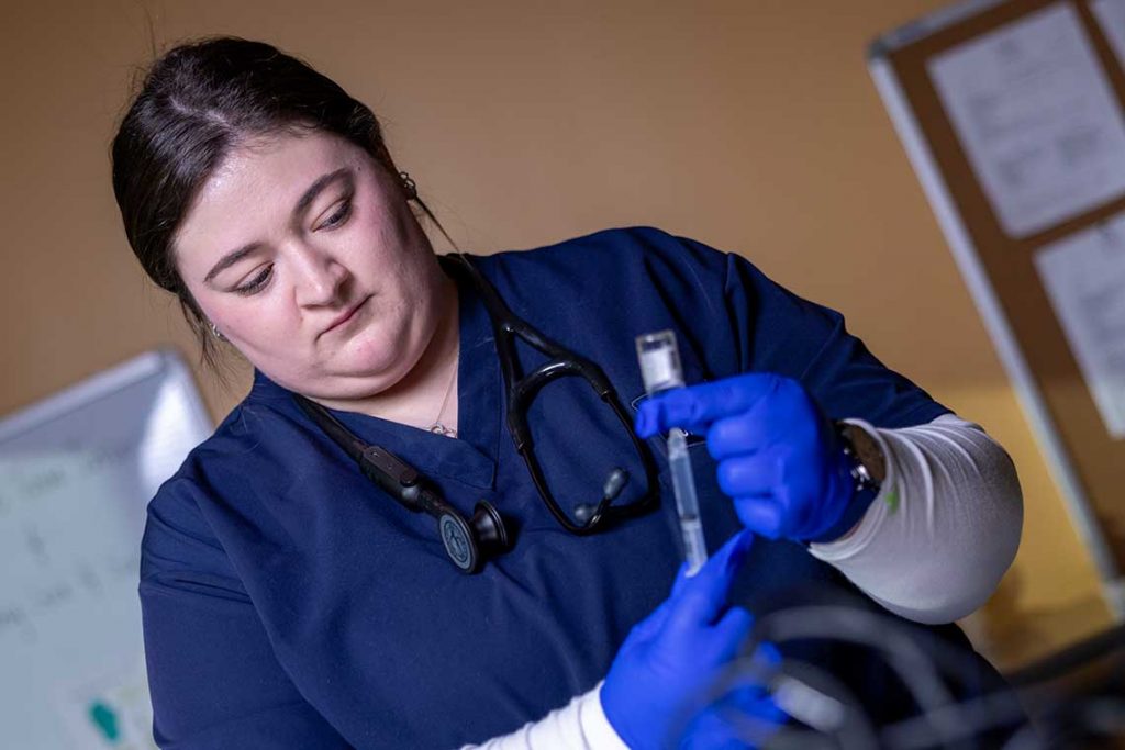 nursing student holding lab equipment