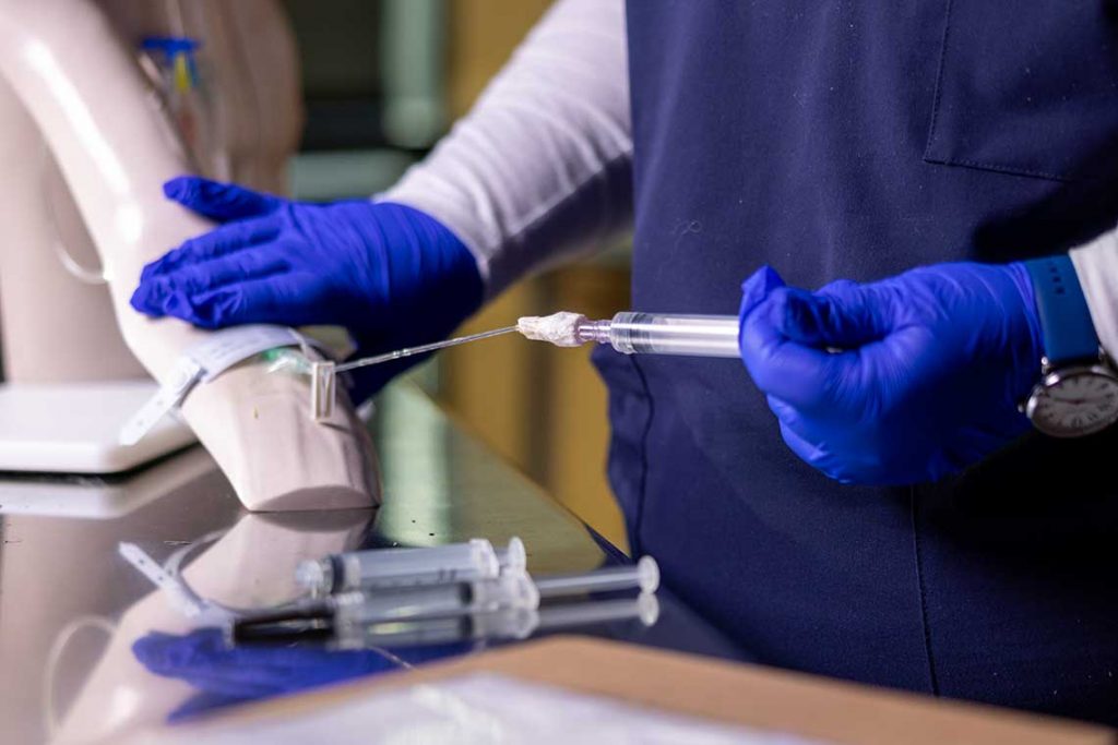 nursing student using lab equipment