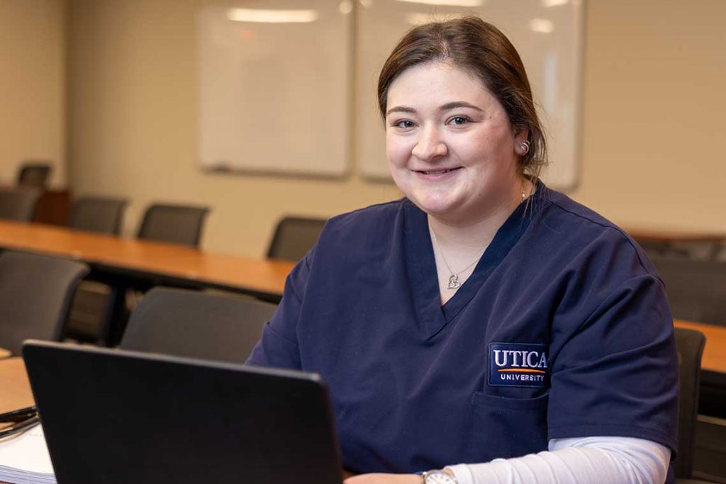 smiling nursing student with laptop