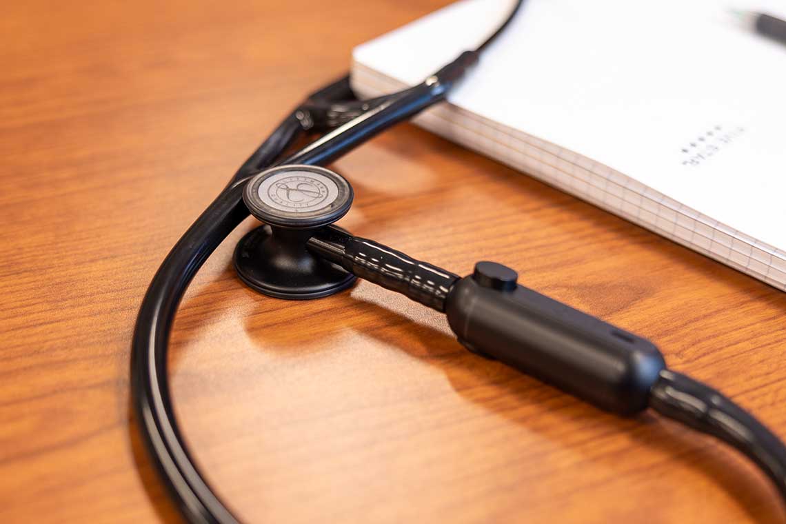 stethoscope on table with book