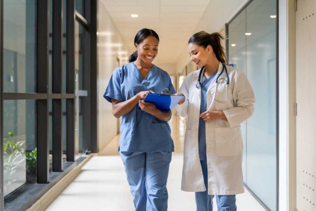 Nurse and doctor walking in hallway talking
