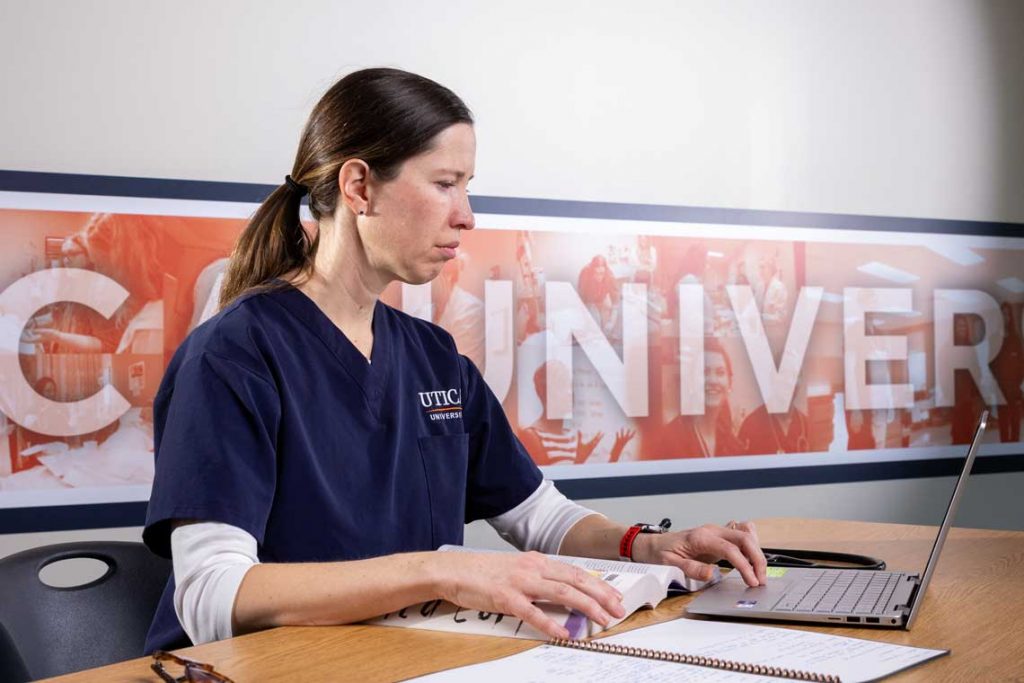 Utica nursing student using laptop