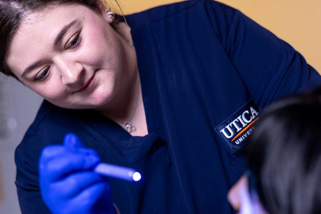 Utica ABSN student working in sim lab