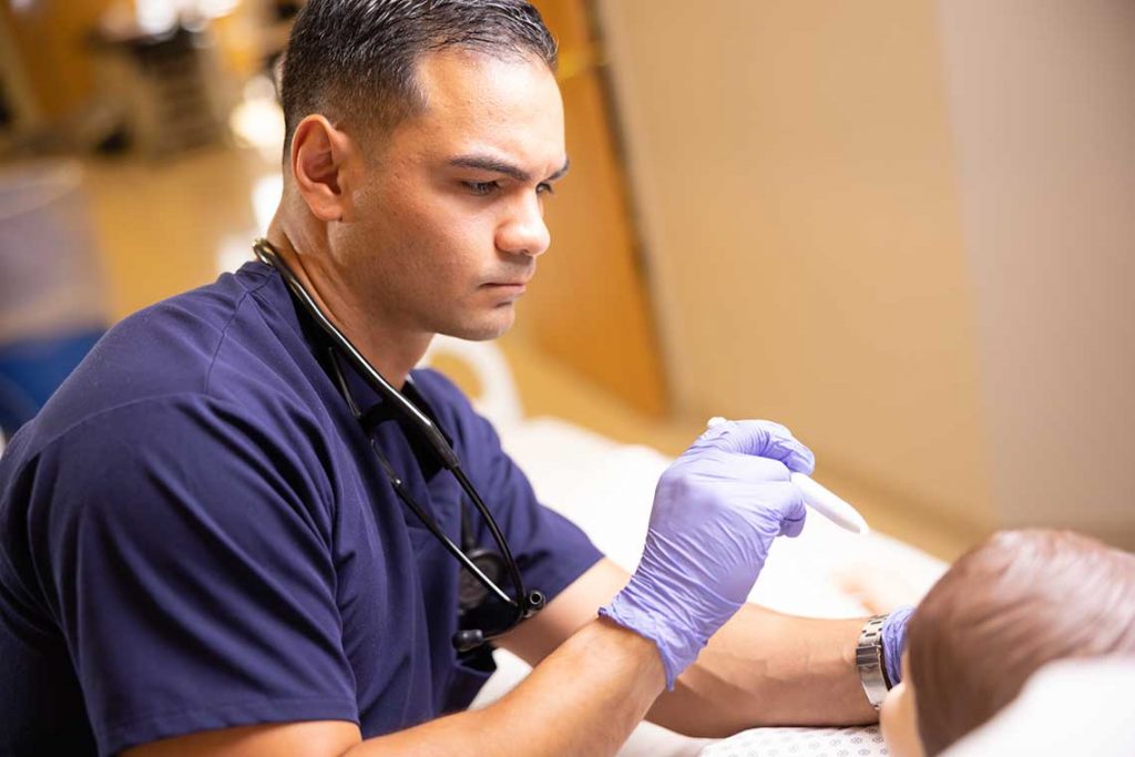 Utica ABSN student working in sim lab